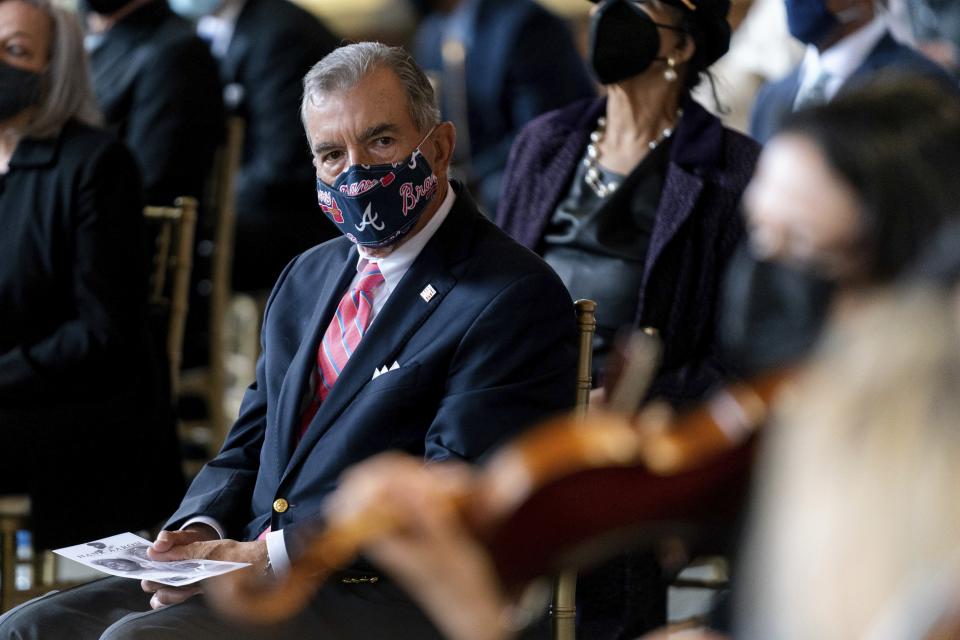 Former Brave Manager John Schuerholz listens to Lark Chamber Music quarter performing "A Celebration of Henry Louis Aaron," a memorial service celebrating the life and enduring legacy of the late Hall of Famer and American icon, on Tuesday, Jan. 26, 2021, at Truist Park in Atlanta. (Kevin D. Liles/Atlanta Braves via AP, Pool)