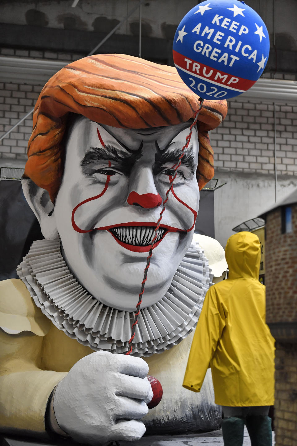 A satiric carnival float depicting US President Donald Trump as horror clown Pennywise is pictured during a preview in a hall in Cologne, Germany, Tuesday, Feb. 18, 2020. The traditional carnival parades on Rosemonday make fun of politics and are watched by hundreds of thousands in the streets of Cologne, Duesseldorf and Mainz. (AP Photo/Martin Meissner)