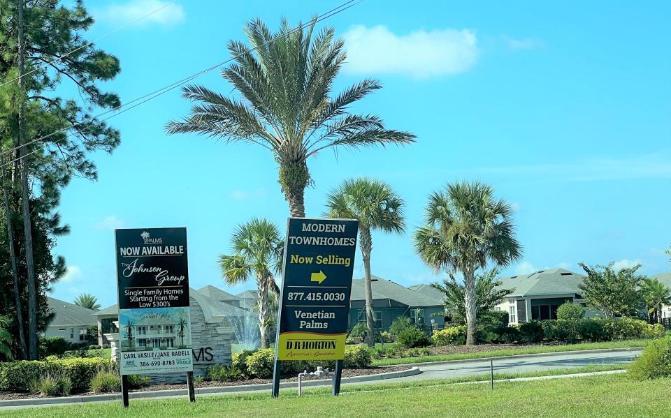 Signs advertising new homes at the Venetian Palms section on the west side of Airport Road at New Smyrna Beach's sprawling Venetian Bay community on Sept. 14, 2023.
