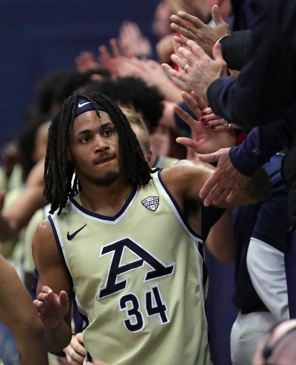 Akron's Nate Johnson celebrates with fans after beating Bradley on Dec. 5, 2023.