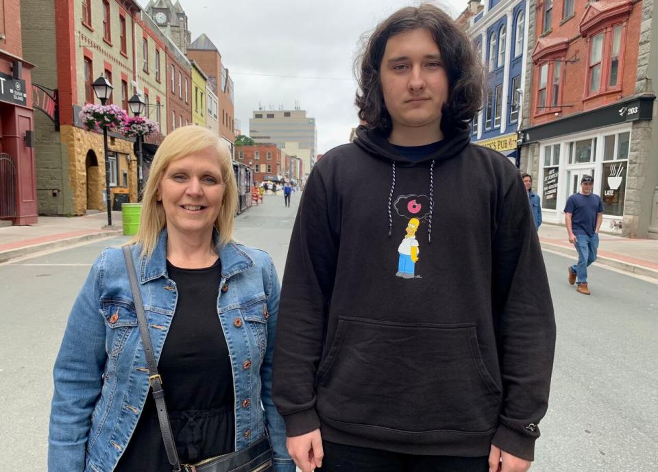 In May 2022, Serhii Semenets fled his home country of Ukraine to move in with Kelly Power, whom he'd never met. Semenets and Power, left, pose for a photo in St. John's, Thursday, Aug. 24, 2023. Semenets is now starting Grade 11 in St. John's, a city he calls his "second home." THE CANADIAN PRESS/Sarah Smellie