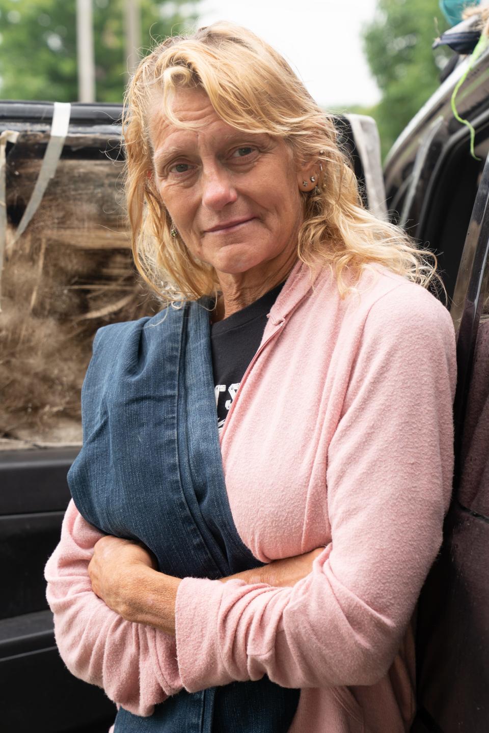 "Until you know the story, don't judge people," says Mary Schierkolk-Ames, shown standing Friday in front of her Jeep in which she lives in North Topeka while referring to how others look at her and other homeless people.