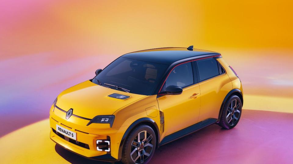 2025 renault 5 etech yellow four door hatchback sits in a studio