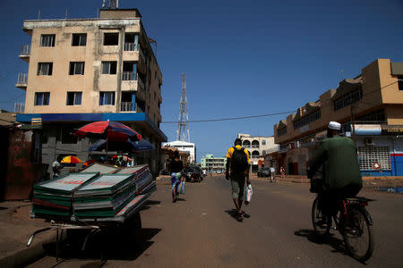 People are seen moving across the street in Banjul, Gambia April 7, 2017. REUTERS/Luc Gnago