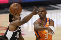 Phoenix Suns guard Chris Paul, right, passes while under pressure from Los Angeles Clippers guard Terance Mann during the first half in Game 3 of the NBA basketball Western Conference Finals Thursday, June 24, 2021, in Los Angeles. (AP Photo/Mark J. Terrill)