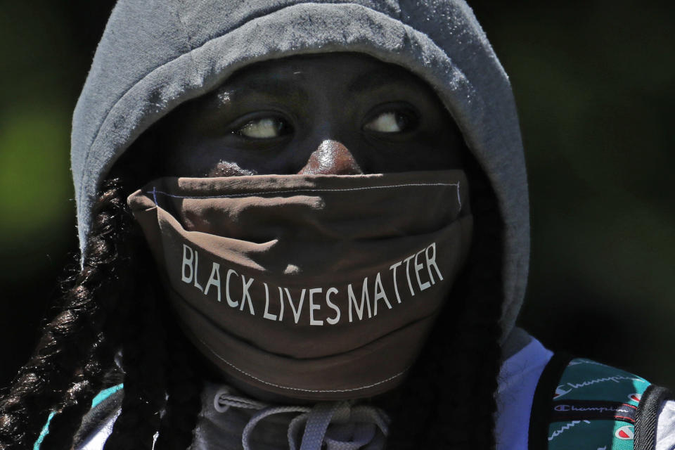 A person wears a mask that reads "Black Lives Matter" during a protest Monday, June 1, 2020, in Tacoma ,Wash., against police brutality and the death of George Floyd, a black man who died after being restrained by Minneapolis police officers on Memorial Day. (AP Photo/Ted S. Warren)