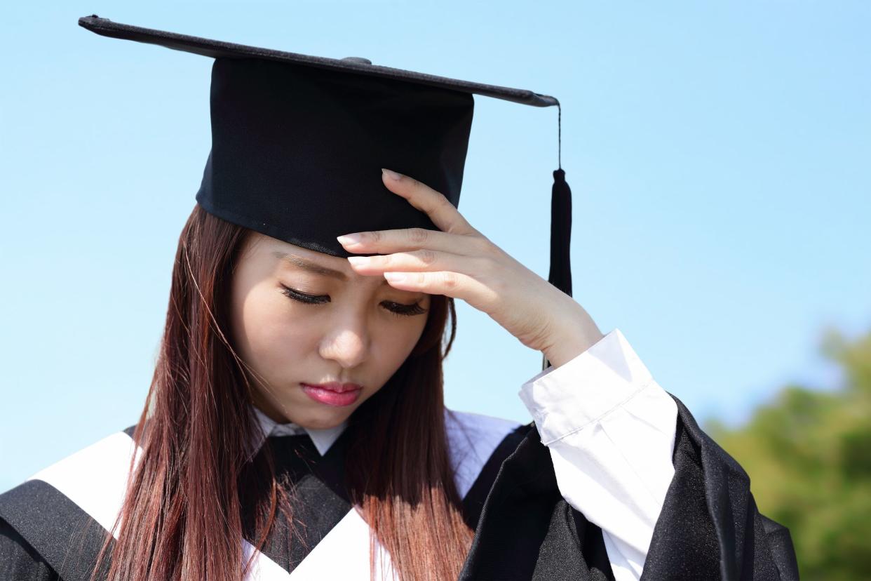 unhappy sad student woman graduating with sky background, asian beauty