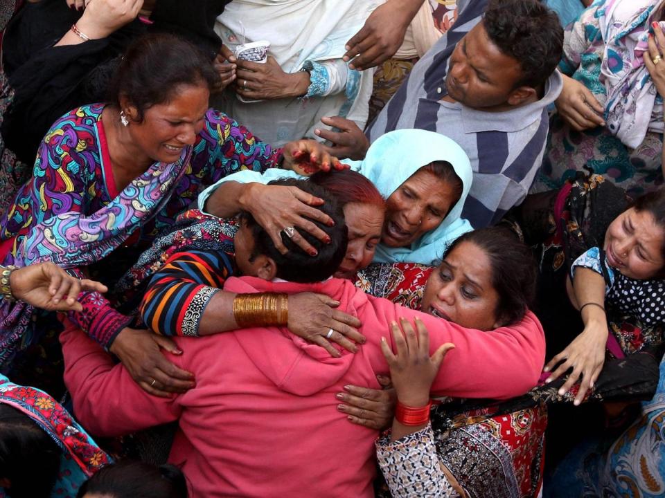 People cry during the funeral of their loved ones a day after a suicide bomb attack at a park, in Lahore, Pakistan, in 2016 (EPA)