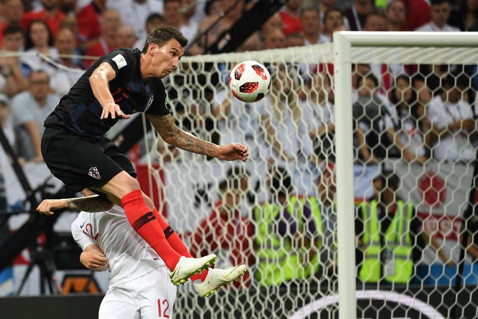 <p>Croatia’s forward Mario Mandzukic (L) vies for the header with England’s defender Kieran Trippier during the Russia 2018 World Cup semi-final football match between Croatia and England at the Luzhniki Stadium in Moscow on July 11, 2018. (Photo by MANAN VATSYAYANA / AFP) </p>