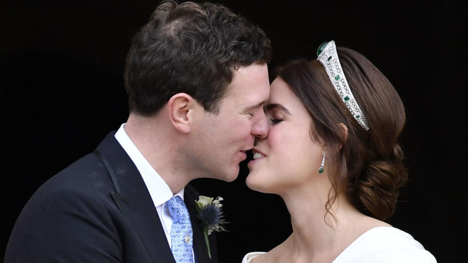 Princess Eugenie and Jack Brooksbank kiss as they leave after their wedding at St George’s Chapel. Source: AAP