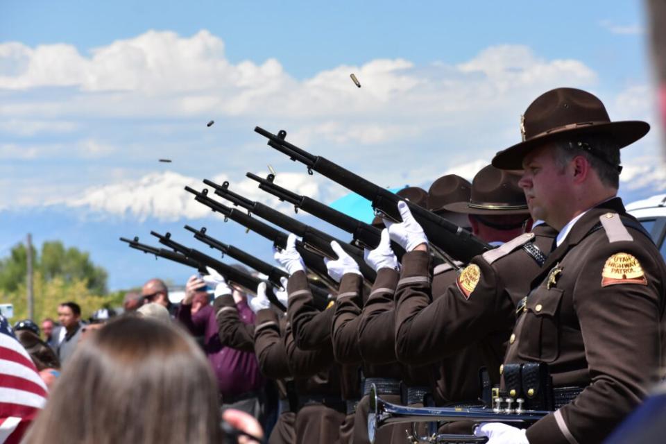  Utah Highway Patrol troopers fire their rifles in a 21-gun salute during the funeral for Santaquin Police Sgt. Bill Hooser at the Santaquin City Cemetery on Monday, May 13, 2024. (Kyle Dunphey/Utah News Dispatch)