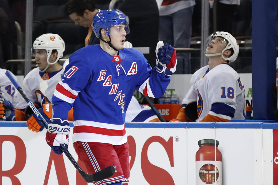 New York Rangers right wing Jesper Fast (17) skates by the New York Islanders bench after scoring a goal against them during the first period of an NHL hockey game, Monday, Jan. 13, 2020, in New York. (AP Photo/Kathy Willens)