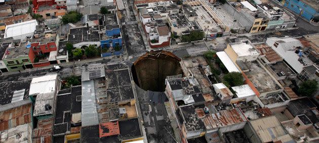 In 2010 a sinkhole covered a street intersection in downtown Guatemala City. Authorities blamed heavy rains caused by tropical storm Agatha as the cause of the crater that swallowed a a three-story building. Credit: AP