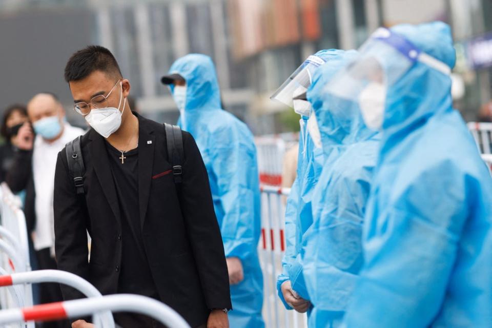 Medical workers carrying out Covid-19 testing in Beijing (REUTERS)