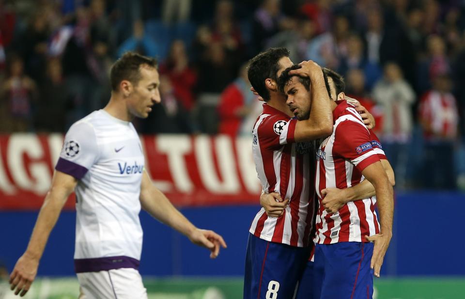 Atletico Madrid's Diego Costa celebrates scoring against Austria Vienna with teammates Raul Garcia (L) and Juan Francisco Torres "Juanfran" (C) during their Champions League Group G soccer match at Vicente Calderon stadium in Madrid November 6, 2013. REUTERS/Susana Vera (SPAIN - Tags: SPORT SOCCER)