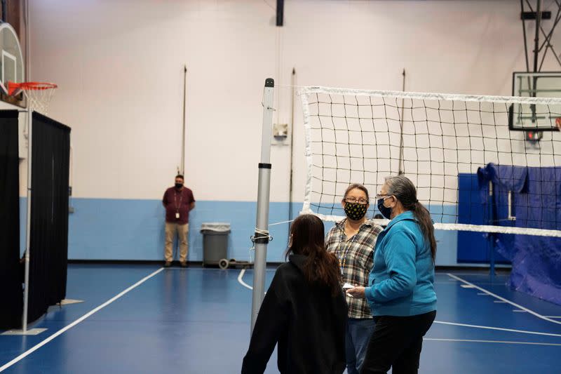 People from rural communities get their coronavirus disease (COVID-19) vaccinations at Menominee Indian High School in Menominee, Wisconsin