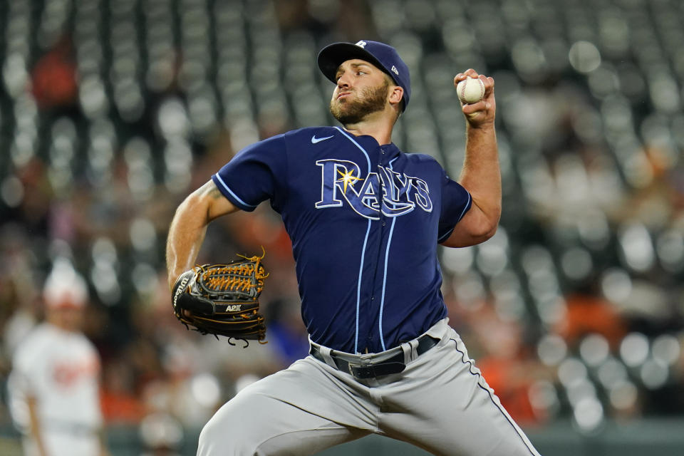 FILE -Tampa Bay Rays relief pitcher Colin Poche throws a pitch to the Baltimore Orioles during the eighth inning of a baseball game, Tuesday, July 26, 2022, in Baltimore. Reliever Colin Poche went to salary arbitration with the Tampa Bay Rays on Tuesday with the sides just $125,000 apart. The gap between the $1.3 million the pitcher asked for and the $1,175,000 the team offered was the smallest among the 33 players who exchanged proposed arbitration figures last month. (AP Photo/Julio Cortez, File)