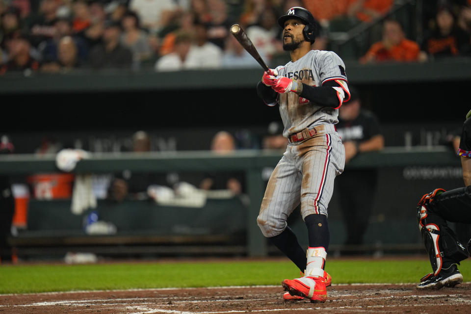 Minnesota Twins' Byron Buxton watches his ball as he hits a three-run home run off Baltimore Orioles relief pitcher Bruce Zimmermann during the fourth inning of a baseball game, Friday, June 30, 2023, in Baltimore. Twins' Joey Gallo and Carlos Correa scored on the home run. (AP Photo/Julio Cortez)