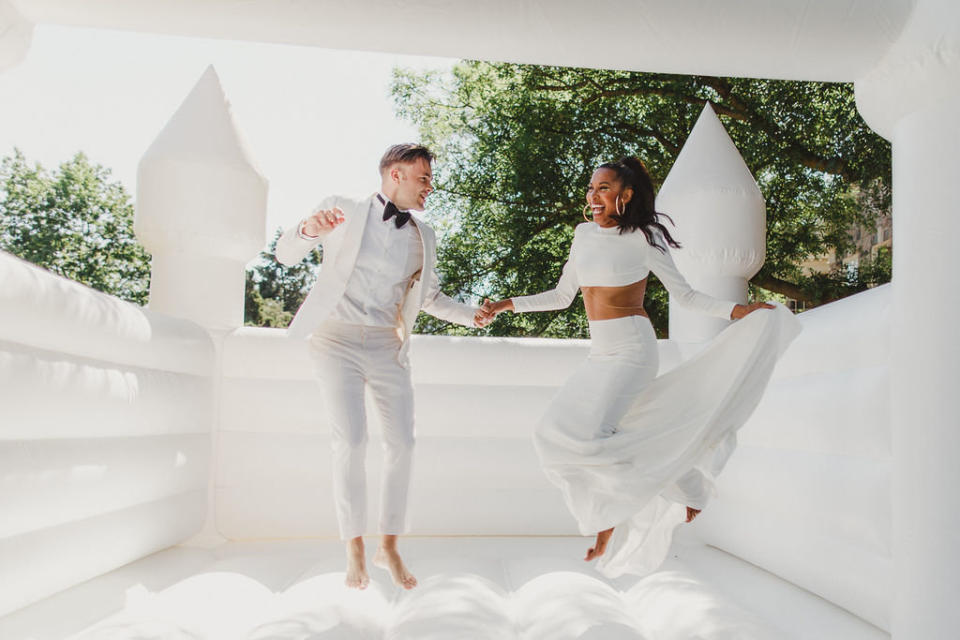 Couple Tiffany and Victor <a href="https://torontolife.com/style/fashion/real-weddings-inside-white-affair-graydon-hall-bouncy-castle-costumed-hype-man/" target="_blank" rel="noopener noreferrer">had a bouncy castle</a> at their July 2017 wedding in Toronto.&nbsp; (Photo: <a href="http://www.avangardphoto.com/" target="_blank">Avangard Photography</a>)