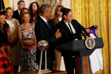 Phoenix Mercury suspended forward Diana Taurasi (right) hands a personalized team jersey to President Barack Obama (left) during a ceremony honoring the 2014 WNBA champion Phoenix Mercury in the East Room at the White House. Mandatory Credit: Geoff Burke-USA TODAY Sports