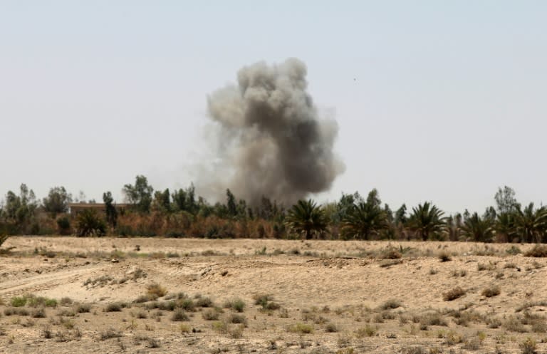 Smoke rises from a village on the outskirts of the city of Fallujah, west of the capital Baghdad, during clashes between Iraqi government forces and Islamic State (IS) group fighters on July 9, 2015