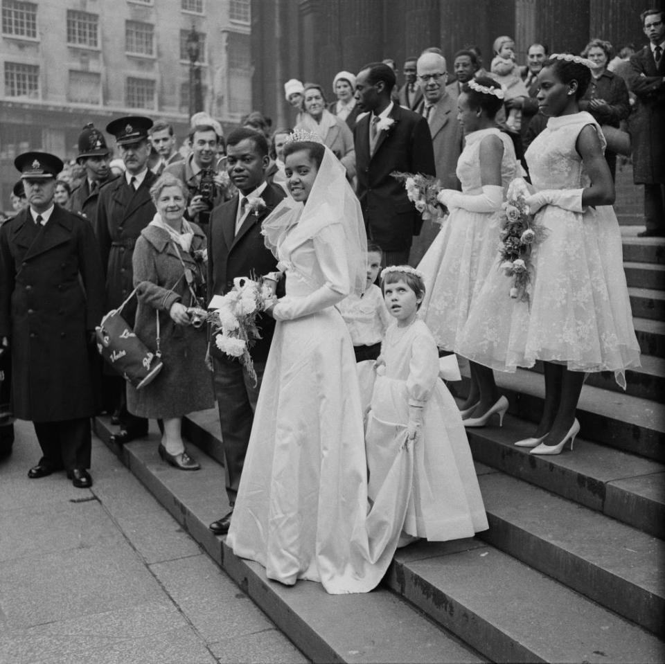 <p>The 1960s were all about the modern and shorter look. High neck collars and sleeveless dresses, like the ones seen on these bridesmaids, were popular styles of the moment. </p>