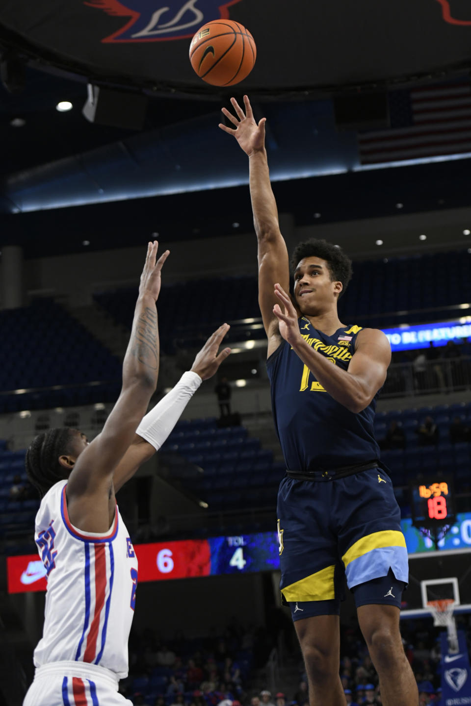 Marquette's Oso Ighodaro (13) goes up for a shot against DePaul's Elijah Fisher (22) during the first half of an NCAA college basketball game Wednesday, Jan 24 2024, in Chicago. (AP Photo/Paul Beaty)