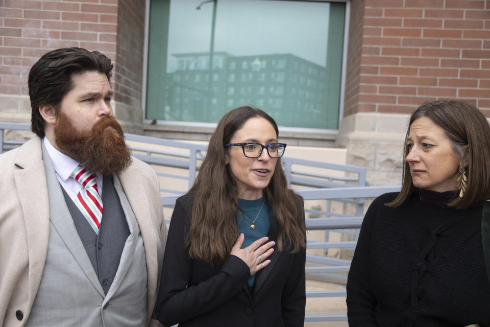 John Adkins, left to right, and his wife Jennifer, along with family physician Julie Lyons talk to the media outside the Ada County Courthouse Thursday, Dec. 14, 2023 in Boise, Idaho. The three are plaintiffs in a case concerning access to abortive care in Idaho. An attorney for Idaho asked a judge on Thursday to throw out a lawsuit seeking clarity about the medical exemptions to the state's broad abortion bans, saying it was based on hypothetical situations rather than current facts. (AP Photo/Kyle Green)