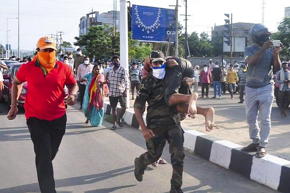 Rescuers evacuate people following a gas leak incident at an LG Polymers plant in Visakhapatnam on May 7, 2020. - At least five people have been killed and several hundred hospitalised after a gas leak at a chemicals plant on the east coast of India, police said on May 7. They said that the gas had leaked out of two 5,000-tonne tanks that had been unattended due to India's coronavirus lockdown in place since late March. (Photo by - / AFP) (Photo by -/AFP via Getty Images)