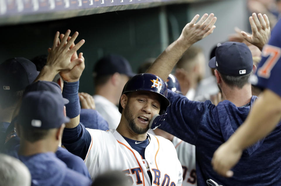 Houston Astros' Yuli Gurriel celebrates with teammates in the dugout after scoring against the Colorado Rockies during the first inning of a baseball game Wednesday, Aug. 15, 2018, in Houston. (AP Photo/David J. Phillip)