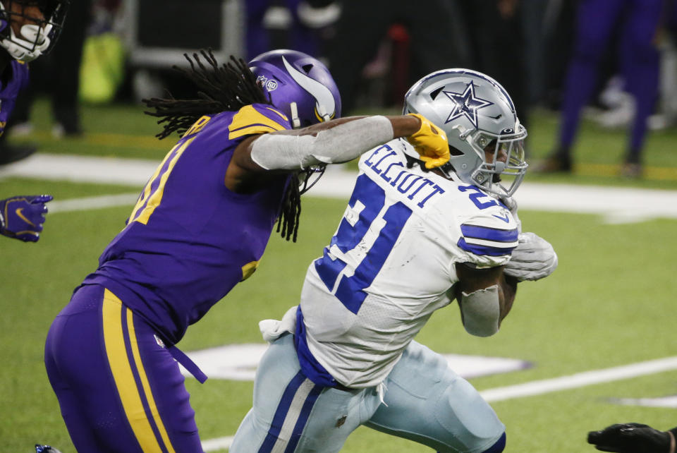 Dallas Cowboys running back Ezekiel Elliott (21) runs from Minnesota Vikings safety Anthony Harris, left, during the second half of an NFL football game, Sunday, Nov. 22, 2020, in Minneapolis. The Cowboys won 31-28. (AP Photo/Bruce Kluckhohn)