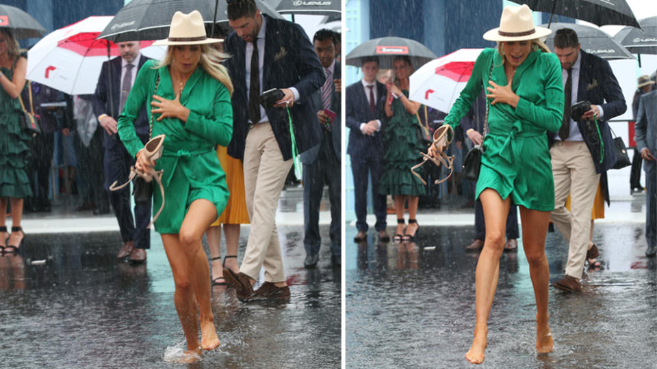 This racegoer was forced to abandon the heels and go barefoot through the pouring rain. Images: AAP