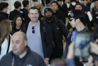 Los Angeles Dodgers' Teoscar Hernandez, center, walks with his wife Jennifer Hernandez, left, during the baseball team's arrival at Incheon International Airport, Friday, March 15, 2024, in Incheon, South Korea, ahead of the team's baseball series against the San Diego Padres. (AP Photo/Ahn Young-joon)