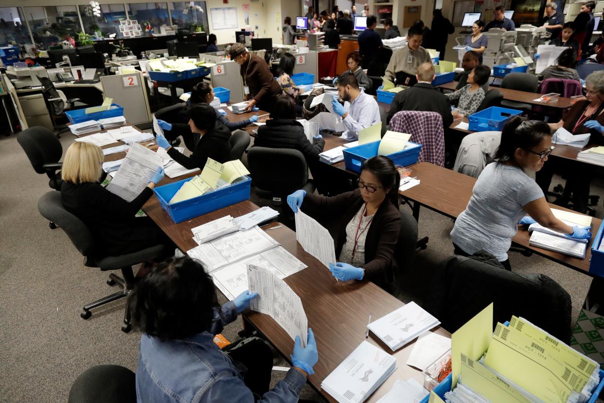 FILE - This Nov. 4, 2016, file photo shows mail-in ballots being sorted at the Santa Clara County Registrar of Voters in San Jose, Calif. Facing an array of unknowns from the coronavirus crisis, California will send every voter a mail-in ballot for the November presidential election, Gov. Gavin Newsom announced Friday, May 8, 2020. (AP Photo/Marcio Jose Sanchez, File)