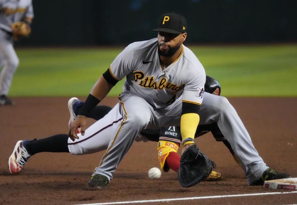 Pittsburgh Pirates' Carlos Santana (41) catches the ball at first base as Arizona Diamondbacks Geraldo Perdomo (2) slides in safely at Chase Field in Phoenix on July 9, 2023.