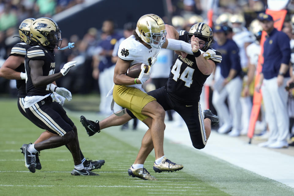 Notre Dame wide receiver Jaden Greathouse (1) is tackled by Purdue defensive back Ayden Murray (44) during the first half of an NCAA college football game in West Lafayette, Ind., Saturday, Sept. 14, 2024. (AP Photo/Michael Conroy)