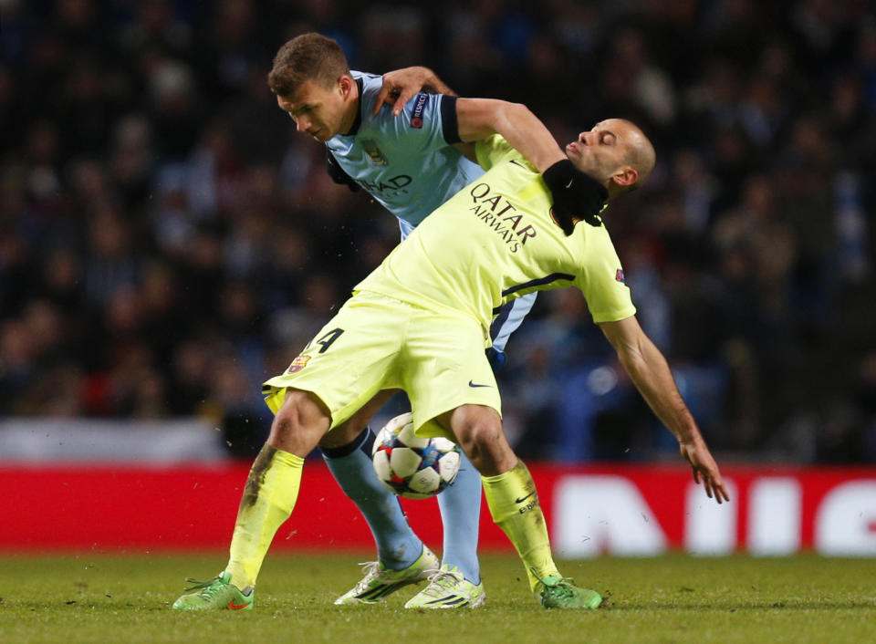 Football - Manchester City v FC Barcelona - UEFA Champions League Second Round First Leg - Etihad Stadium, Manchester, England - 24/2/15 Manchester City's Edin Dzeko in action with Barcelona's Javier Mascherano Action Images via Reuters / Jason Cairnduff Livepic EDITORIAL USE ONLY.