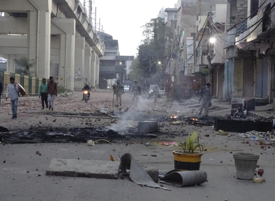 A vandalized street following violence between two groups in New Delhi, India, Tuesday, Feb. 25, 2020. An angry group of Hindus carrying pickaxes and iron rods hurled rocks at Muslims in new violence in the Indian capital over a new citizenship law on Tuesday, with at least 10 people killed in two days of clashes that cast a shadow over U.S. President Donald Trump's visit to the country. (AP Photo/Dinesh Joshi)