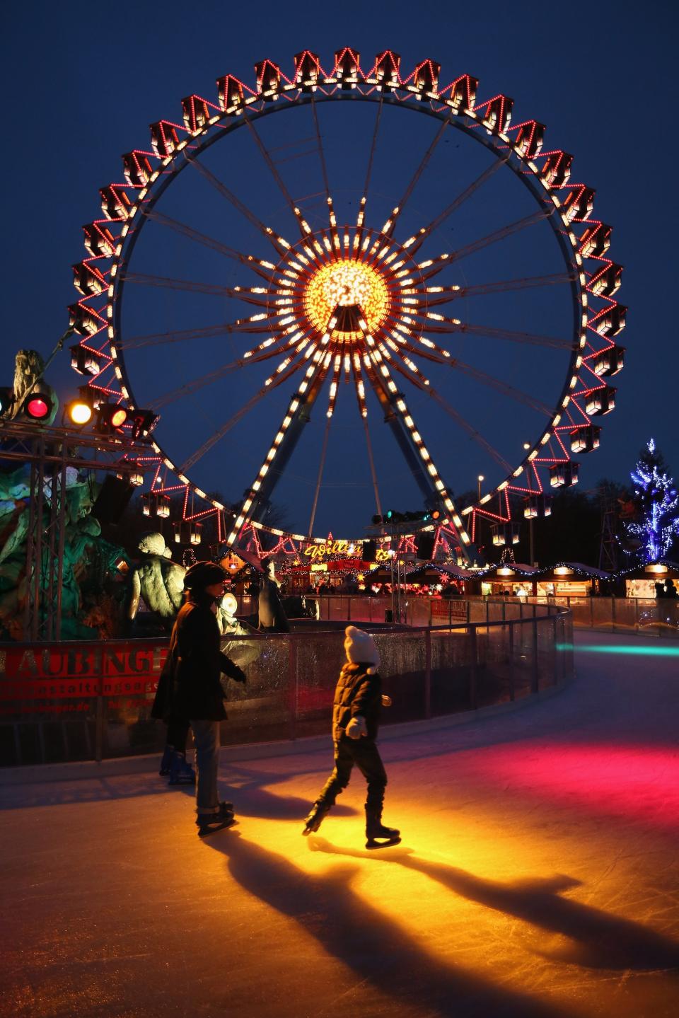 BERLIN, GERMANY - NOVEMBER 28: Visitors skate on an ice rink at the annual Christmas market at Alexanderplatz two days after the market opened on November 28, 2012 in Berlin, Germany. Christmas markets, with their stalls selling mulled wine (Gluehwein), Christmas tree decorations and other delights, are an integral part of German Christmas tradition, and many of them are opening across Germany this week. (Photo by Sean Gallup/Getty Images)