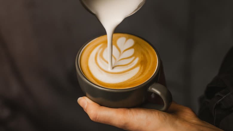 Pouring milk into cappuccino 