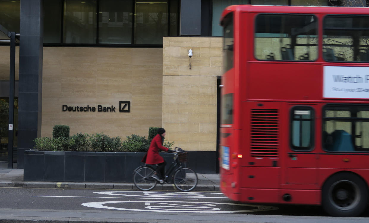 FTSE A woman cycles behind a London bus as they pass by a Deutsche Bank building in the City of London March 30, 2016.     REUTERS/Russell Boyce