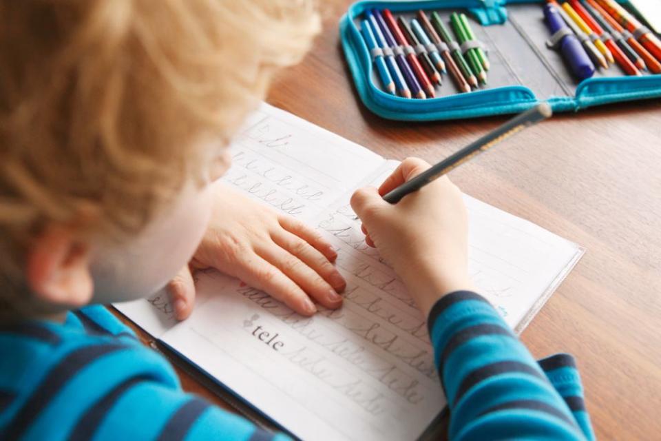 Child practicing cursive | Getty