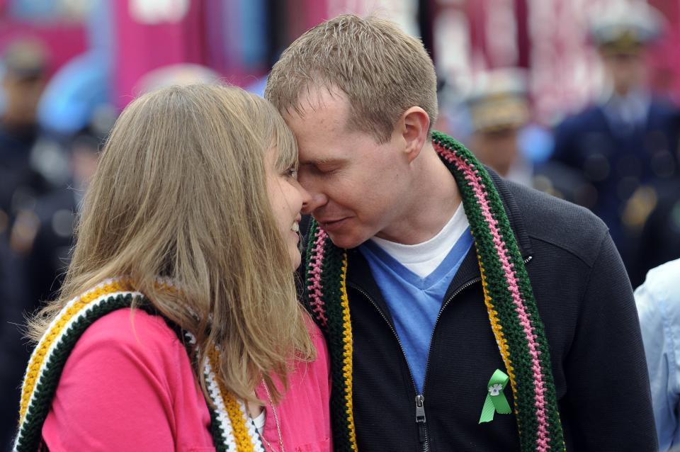 Michele Gay and Alissa Parker (pictured here with husband Robbie) lean on their families and each other for support during hard times. (Photo: Hartford Courant via Getty Images)