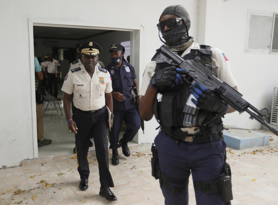FILE - Leon Charles, left, Director General of Haiti's Police leaves a room after a news conference at police headquarters in Port-au-Prince, Wednesday, July 14, 2021. Charles gave an update on the investigation of the July 7 assassination of President Jovenel Moise. A judge investigating the July 2021 assassination of President Moïse issued a final report on Monday, Feb. 19, 2024, that indicts his widow, Martine Moïse, ex-prime minister Claude Joseph and the former chief of Haiti’s National Police, Charles, among others. (AP Photo/Fernando Llano, File)