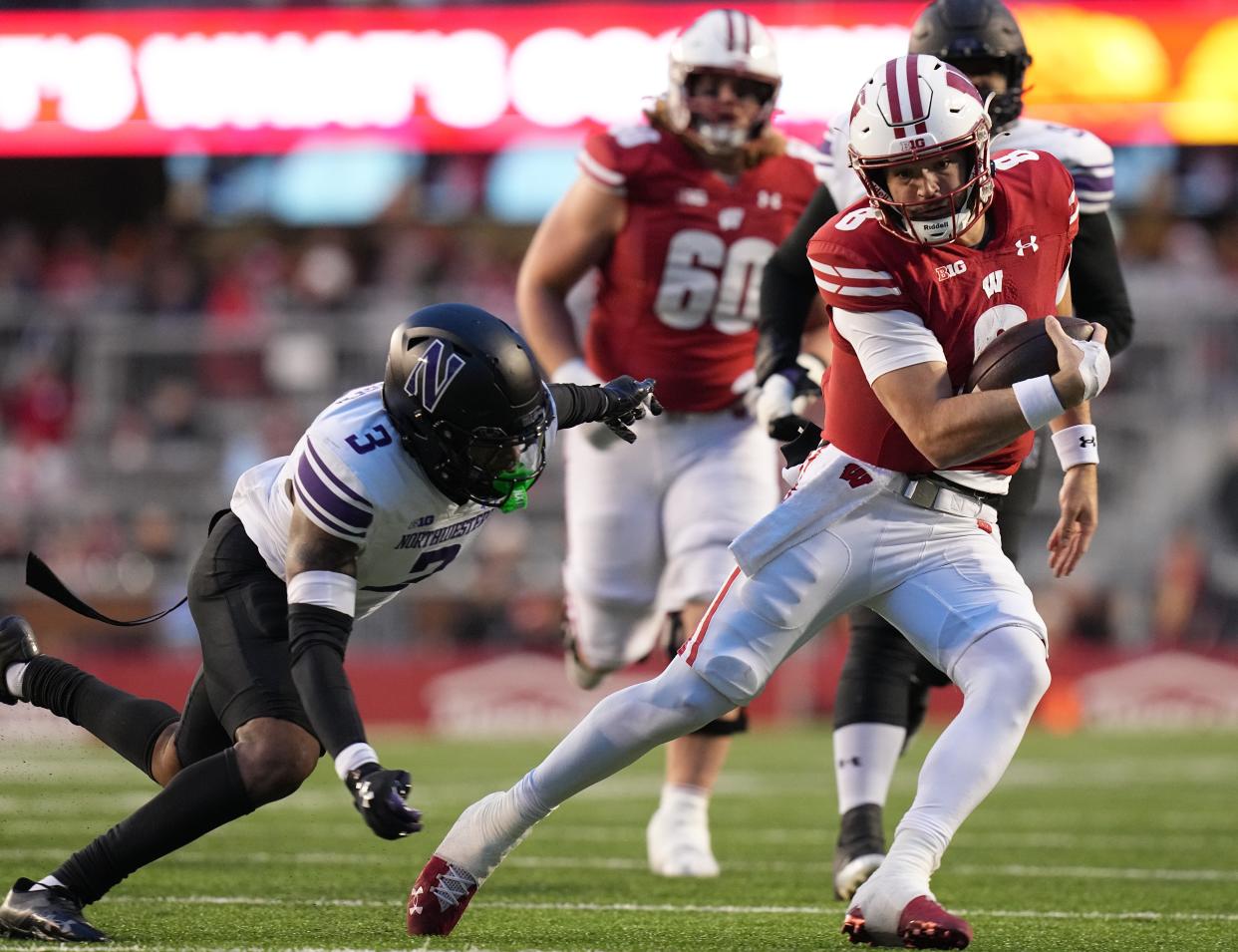 Wisconsin quarterback Tanner Mordecai runs for a first down against Northwestern.