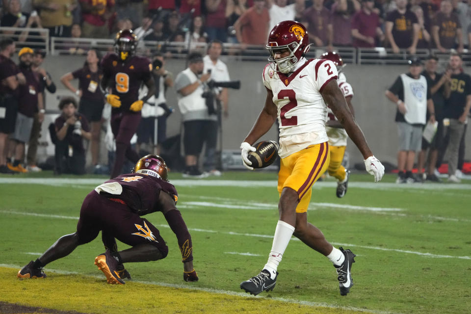 Southern California wide receiver Brenden Rice (2) scores a touchdown in front of Arizona State defensive back Demetries Ford during the first half of an NCAA college football game, Saturday, Sept. 23, 2023, in Tempe, Ariz. (AP Photo/Rick Scuteri)