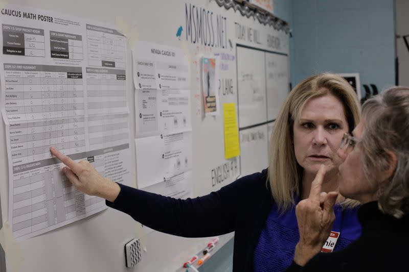 Volunteers check their math at a Nevada Caucus voting site at Coronado High School in Henderson