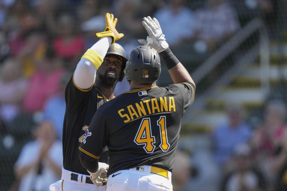 Pittsburgh Pirates Carlos Santana (41) is greeted at the plate by Andrew McCutchen after the two scored on Santana's home run in the fourth inning of a spring training baseball game against the Toronto Blue Jays in Bradenton, Fla., Tuesday, March 7, 2023. (AP Photo/Gerald Herbert)