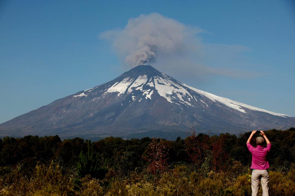 Smoke and ash rises from the Villarrica volcano as seen from Pucon town south of Santiago