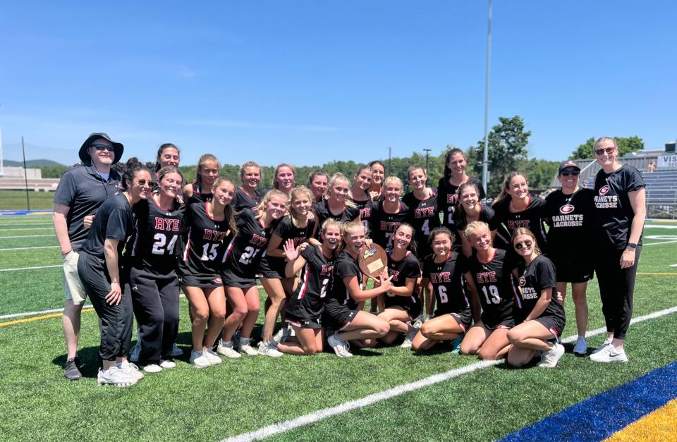 The Rye girls lacrosse team celebrates with championship plaque photo after its Class C state regional final win over Queensbury High School June 1, 2024.